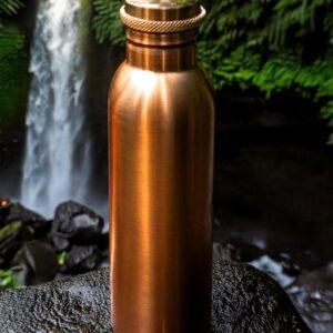 copper water bottle by waterfall