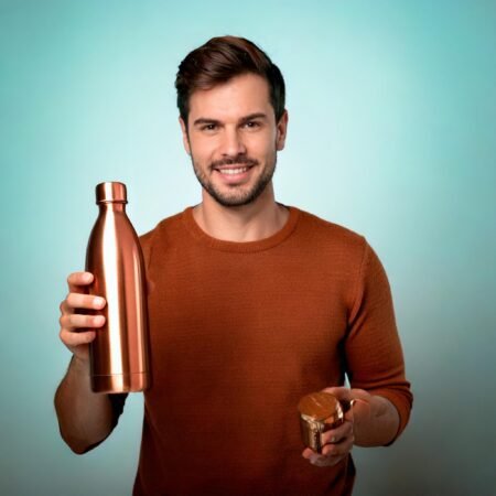 man holding copper water bottle health